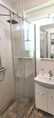 a bathroom with a shower and a sink at Gala City Center Apartman in Belgrade