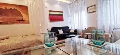a living room with a glass table and a couch at Gala City Center Apartman in Belgrade