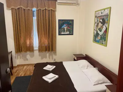 a bedroom with a bed with two towels on it at Traveling Actor Skadarlija in Belgrade