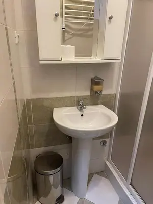 a small bathroom with a sink and a mirror at Traveling Actor Skadarlija in Belgrade
