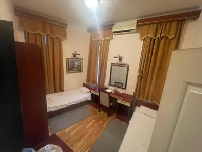 a room with a bed and a desk and a mirror at Traveling Actor Skadarlija in Belgrade