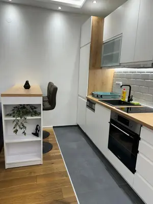 a kitchen with white cabinets and a counter top at Apartment, Stari Grad, Belgrade in Belgrade