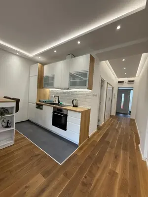 a kitchen with white cabinets and a wooden floor at Apartment, Stari Grad, Belgrade in Belgrade