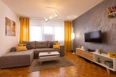 a living room with a couch and a tv at Apartman 22 in Belgrade