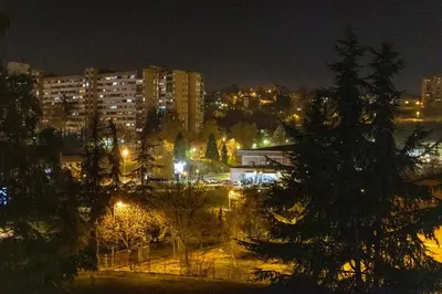 a view of a city at night with lights at Apartman 22 in Belgrade