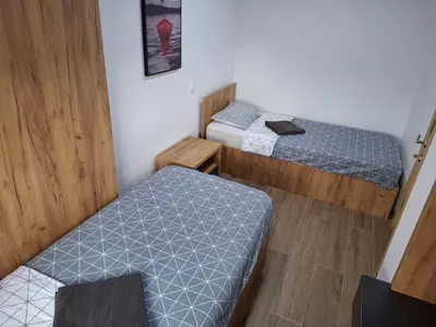 two beds in a small room with at Serbian home - 44, Gandijeva 184, free parking in Bežanija