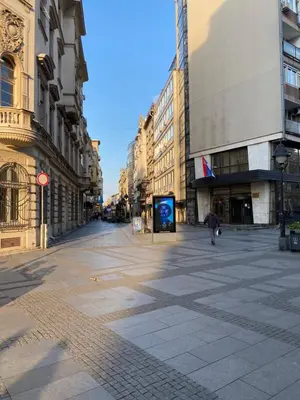 a person walking down a street in a city at Dragon in Belgrade