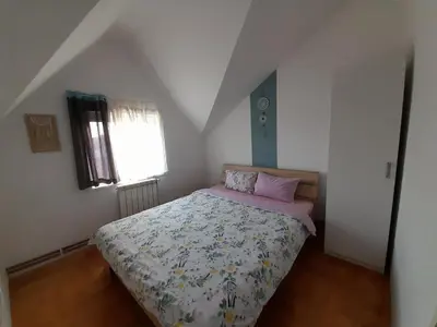 a bedroom with a bed and a window at Apartment Ken in Surčin