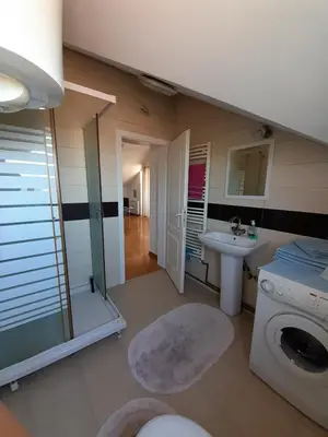 a bathroom with a washing machine and a sink at Apartment Ken in Surčin