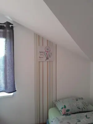 a bedroom with a bed and a poster on the wall at Apartment Ken in Surčin