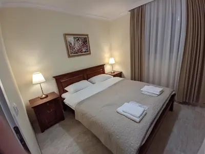 a bedroom with a bed with two towels on it at Apartmani Danube LUX Smederevo in Smederevo