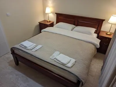 a bedroom with a bed with two towels on it at Apartmani Danube LUX Smederevo in Smederevo