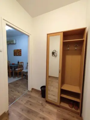 a hallway with a door and a room with a table at Apartment Kaja in Belgrade