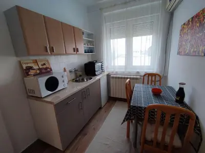 a small kitchen with a table and a microwave at Apartment Kaja in Belgrade