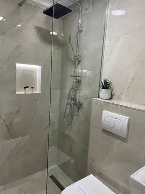 a shower with a glass door in a bathroom at Galaxy Apartments in Belgrade