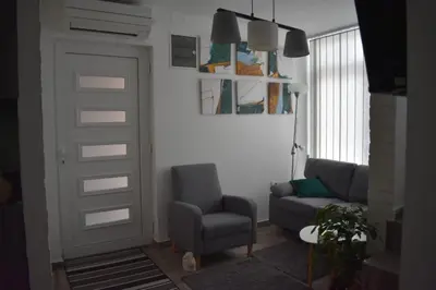 a living room with a chair and a door at Damun in Belgrade