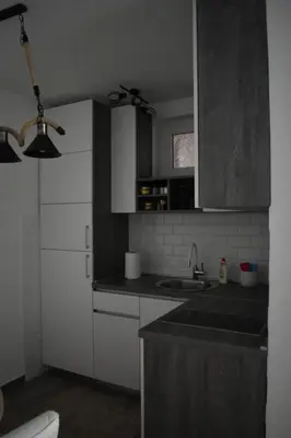 a kitchen with white cabinets and a sink at Damun in Belgrade