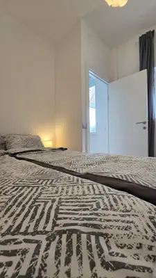 a bedroom with a large bed with a bedspread on it at Apartment Major in Belgrade