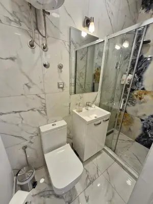 a white bathroom with a toilet and a shower at Apartment Major in Belgrade