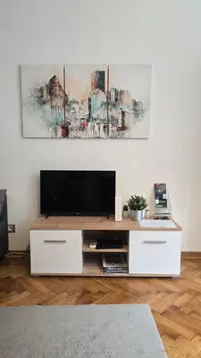 a living room with a television on a white wall at Apartment Major in Belgrade