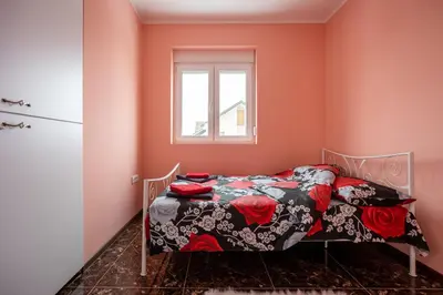 a bedroom with a bed and a window at Mici Luxury Apartments in Ledine