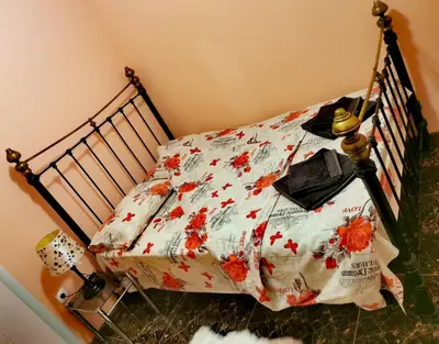 a bedroom with a bed with red flowers on it at Mici Luxury Apartments in Ledine