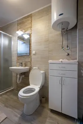 a bathroom with a toilet and a sink and a mirror at Mici Luxury Apartments in Ledine