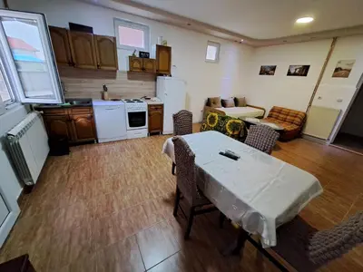 a kitchen with a table and chairs in a room at Apartmani MilaMi #1 in Belgrade