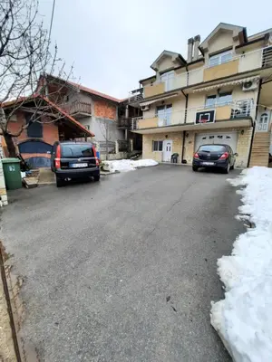 two cars parked on a street next to a building at Apartmani MilaMi #1 in Belgrade