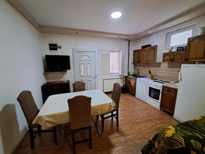 a kitchen with a table and chairs in a room at Apartmani MilaMi #1 in Belgrade