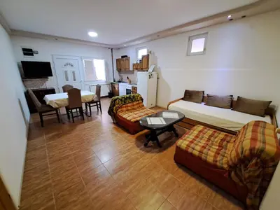 a living room with two beds and a couch and a table at Apartmani MilaMi #1 in Belgrade