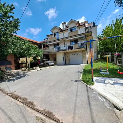 an empty street in front of a house at Apartmani MilaMi #1 in Belgrade
