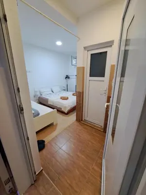 a small bedroom with a bed and a door at Apartmani MilaMi #1 in Belgrade