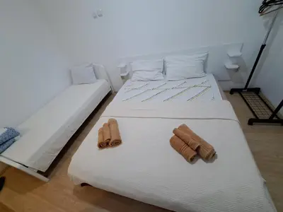 a bedroom with two beds with towels on them at Apartmani MilaMi #1 in Belgrade