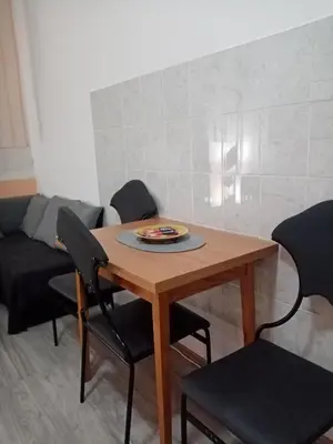 a dining room table with chairs and a plate on it at Apartment Anna in Belgrade