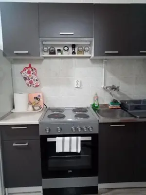 a kitchen with a black stove and a sink at Apartment Anna in Belgrade