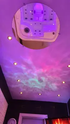 a purple ceiling with clouds painted on it at Aurora Lux Spa Smart apartments in Belgrade