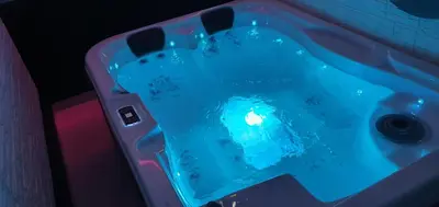 a bath tub with blue water in it at Aurora Lux Spa Smart apartments in Belgrade