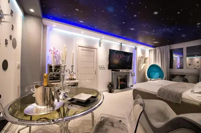 a bedroom with a starry ceiling and a bed and a table at Aurora Lux Spa Smart apartments in Belgrade