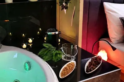 a bathroom with a bath tub and a sink at CHILLA MILLA in Sajmište