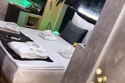 a bed with white towels on top of it at CHILLA MILLA in Sajmište