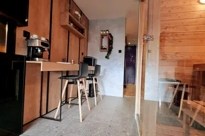 a kitchen with stools at a counter in a room at CHILLA MILLA in Sajmište