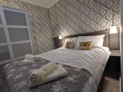a bedroom with a bed with towels on it at Danka in Belgrade