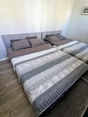 two beds sitting next to each other in a bedroom at Danka in Belgrade