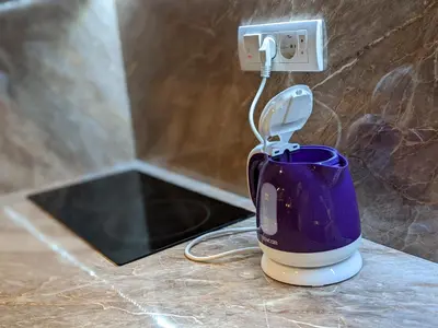 a purple cup sitting on a counter next to an electrical outlet at Danka in Belgrade