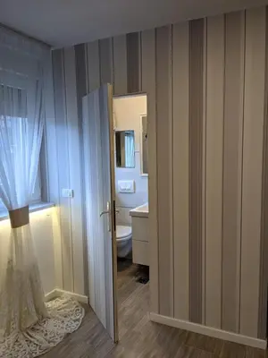 a bathroom with a door open to a bathroom with a toilet at Danka in Belgrade