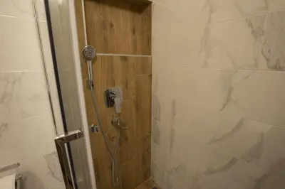 a shower with a phone in a bathroom at Belgrade apartment Bulevar in Belgrade