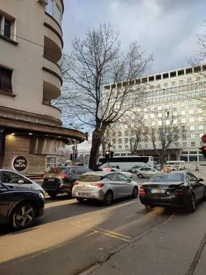 a busy city street with cars parked in front of buildings at Belgrade apartment Bulevar in Belgrade