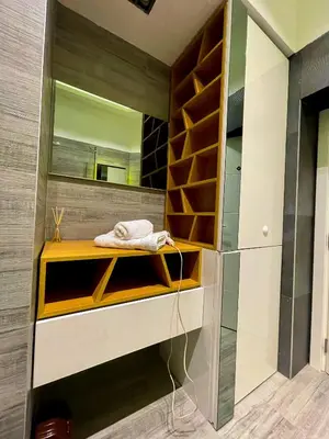 a bathroom with a wooden shelf and a mirror at The Bohemian Residence in Belgrade