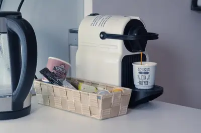 a coffee maker and a basket on a counter at The Bohemian Residence in Belgrade